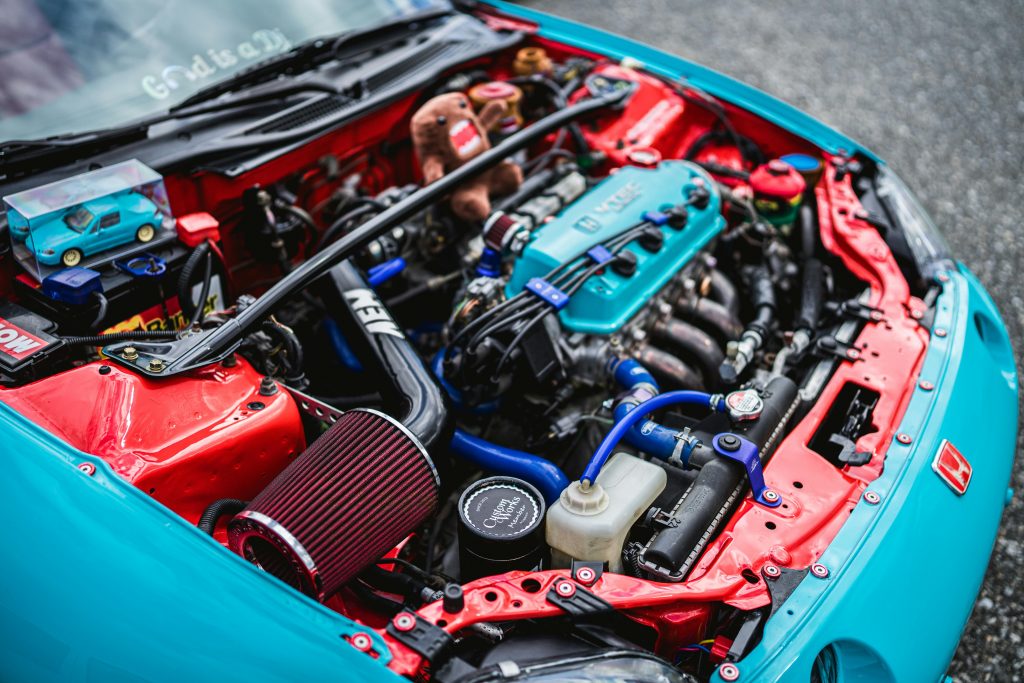 Detailed view of customized Honda engine in vibrant colors.