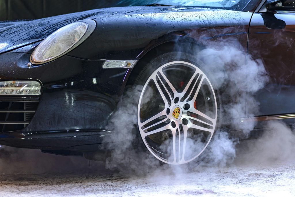 pexels photo 248370 248370 Close-up of a luxury car wheel with steam and water droplets, showcasing power and style.